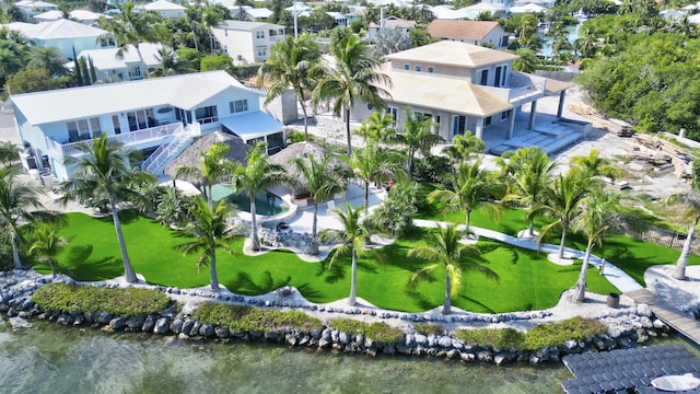 birds eye view of property with a water view and a residential view