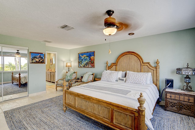 bedroom with a textured ceiling, visible vents, a ceiling fan, and baseboards