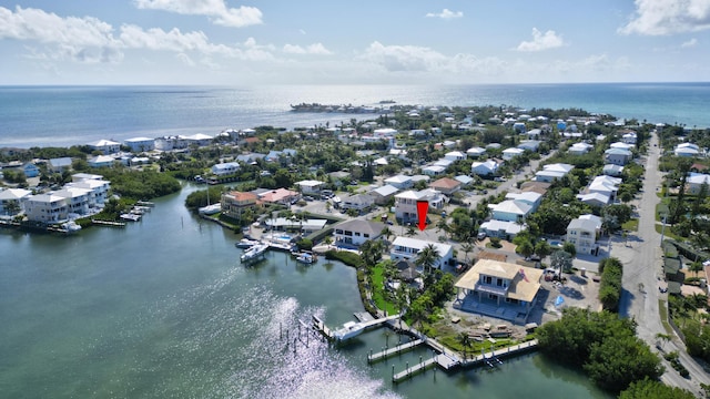 birds eye view of property featuring a water view and a residential view