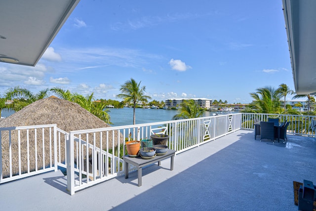 view of patio / terrace featuring a water view and a balcony