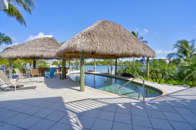 pool featuring a patio area, a gazebo, and a water view