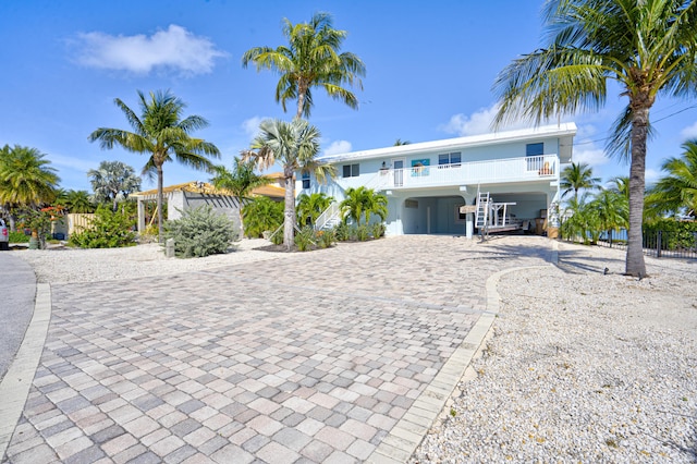 beach home featuring decorative driveway