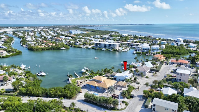 drone / aerial view featuring a residential view and a water view