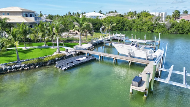 view of dock with a lawn, a water view, and boat lift