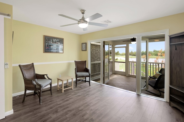 living area featuring hardwood / wood-style floors and ceiling fan