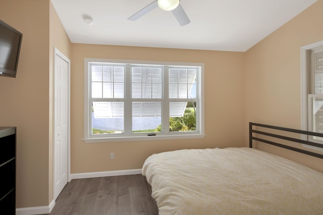 bedroom with wood-type flooring and ceiling fan