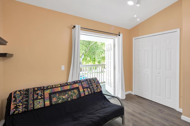 bedroom with hardwood / wood-style flooring, vaulted ceiling, access to outside, and a closet