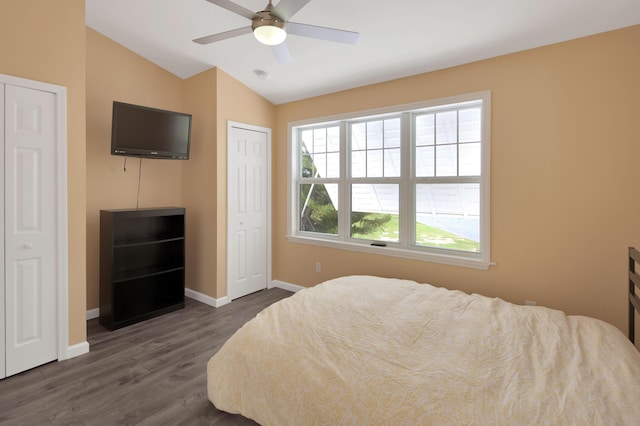 bedroom featuring lofted ceiling, dark hardwood / wood-style floors, and ceiling fan