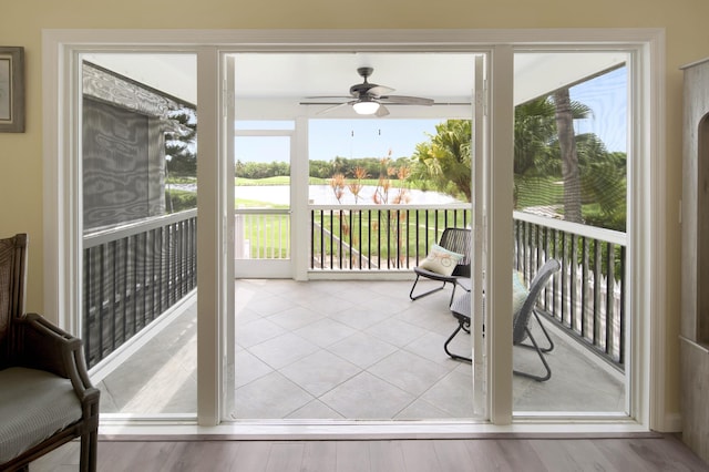 sunroom / solarium featuring ceiling fan