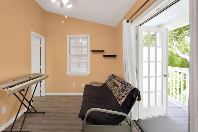 sitting room featuring dark wood-type flooring and vaulted ceiling