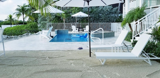 view of swimming pool featuring a patio and a fenced in pool