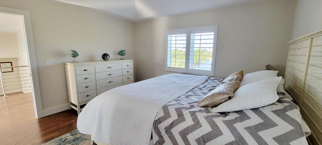 bedroom featuring baseboards and wood finished floors