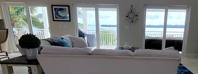 living room featuring plenty of natural light and a water view