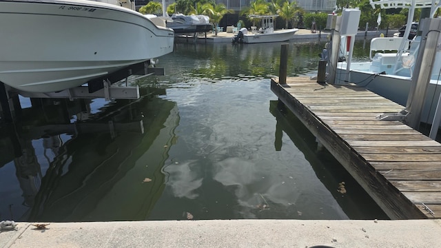 view of dock with a water view and boat lift