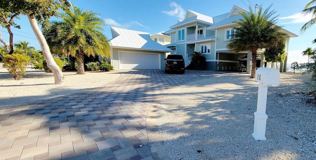 view of front of property with driveway, metal roof, and a standing seam roof