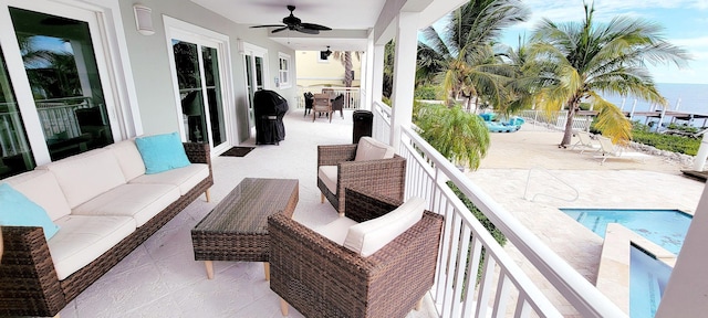 view of patio / terrace with an outdoor living space, outdoor dining area, a water view, and a ceiling fan