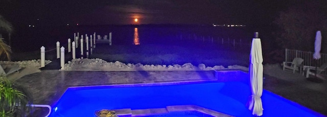 view of pool at night