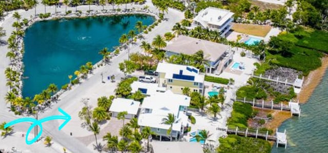 birds eye view of property with a water view