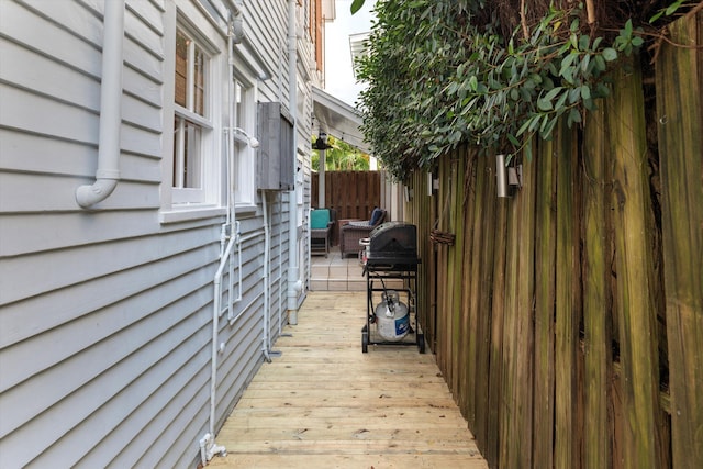 wooden deck with grilling area and fence