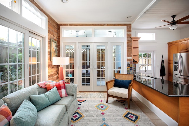 sunroom / solarium with a sink and french doors