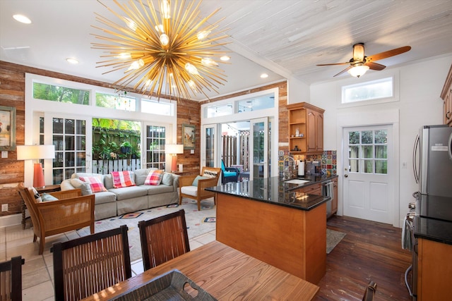 kitchen with appliances with stainless steel finishes, open floor plan, a peninsula, open shelves, and a sink