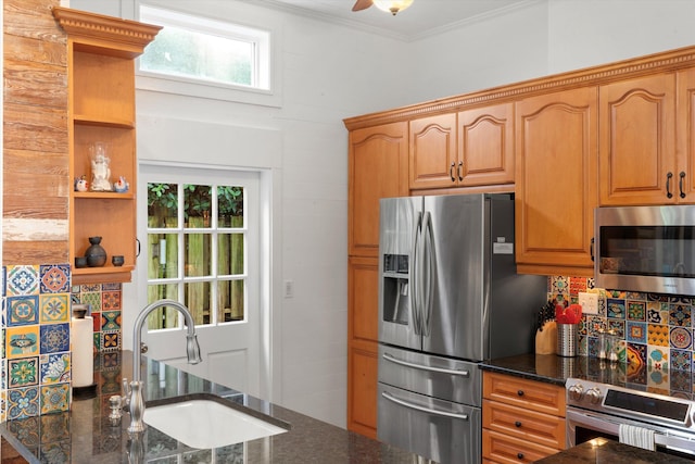 kitchen with dark stone countertops, appliances with stainless steel finishes, open shelves, and a sink