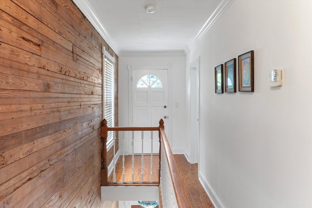 entryway with ornamental molding, wood finished floors, and baseboards