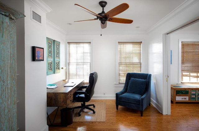 office with baseboards, visible vents, ceiling fan, ornamental molding, and wood finished floors