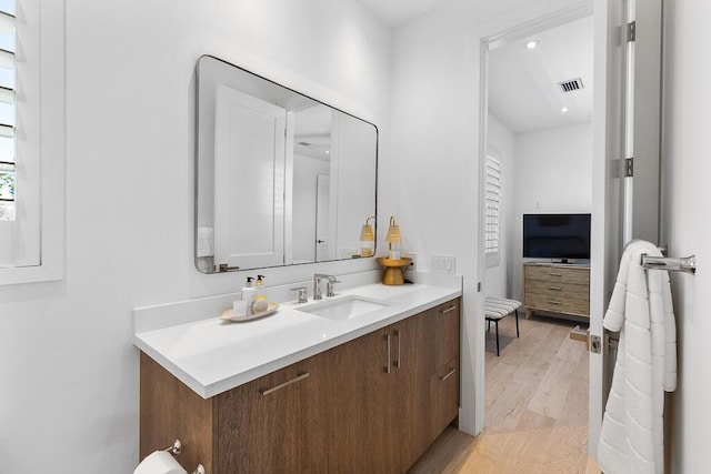 bathroom with hardwood / wood-style flooring and vanity