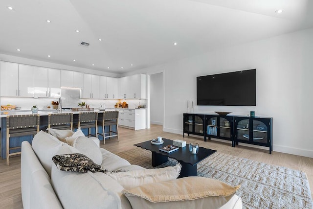 living room with light hardwood / wood-style flooring