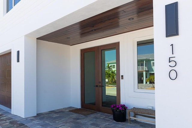 property entrance featuring a patio and french doors