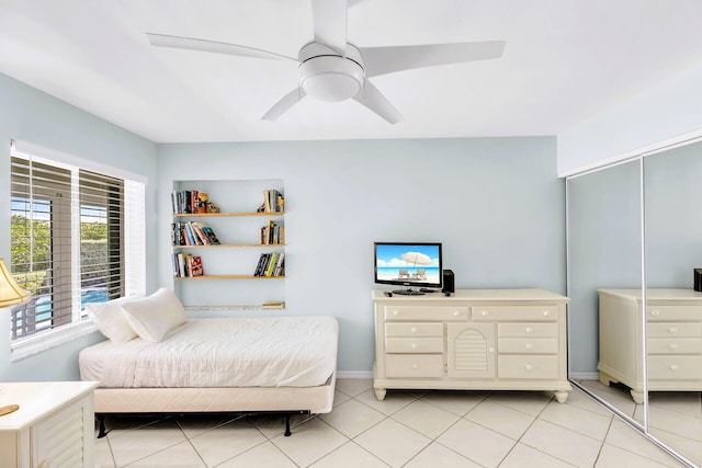 tiled bedroom featuring a closet and ceiling fan