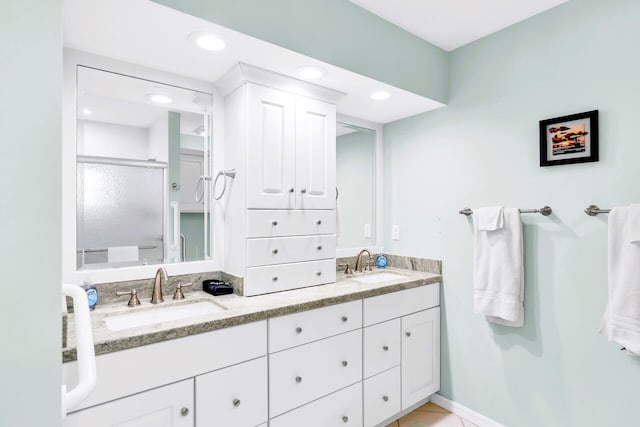 bathroom with vanity and a shower with shower door