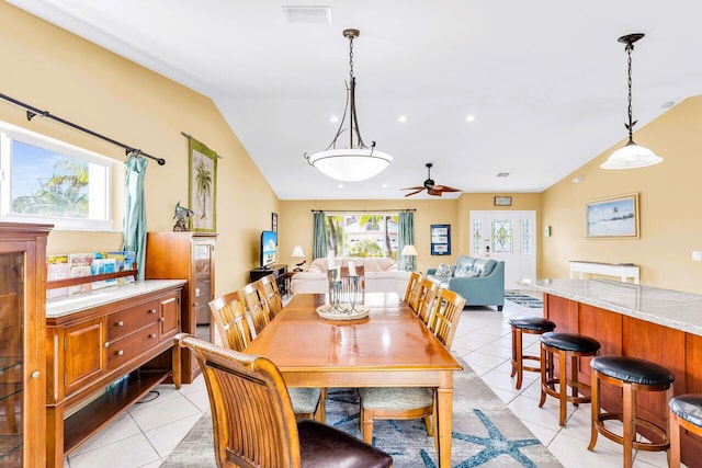 dining area featuring ceiling fan, lofted ceiling, and light tile patterned floors