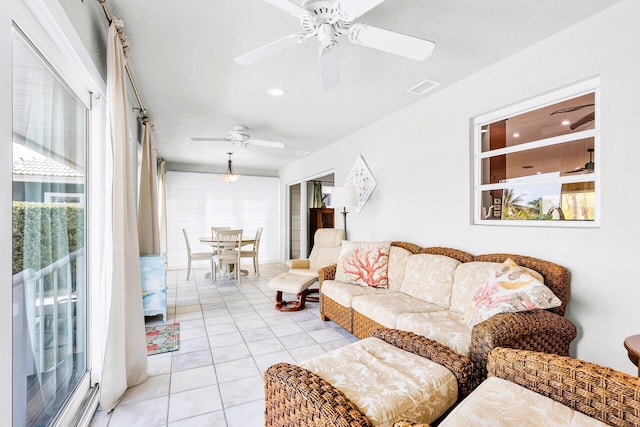 living room with light tile patterned floors and ceiling fan