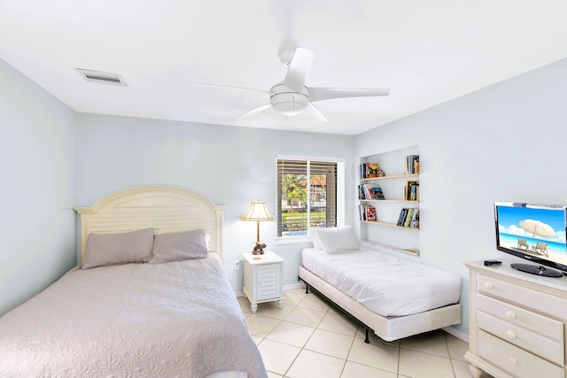 tiled bedroom featuring ceiling fan