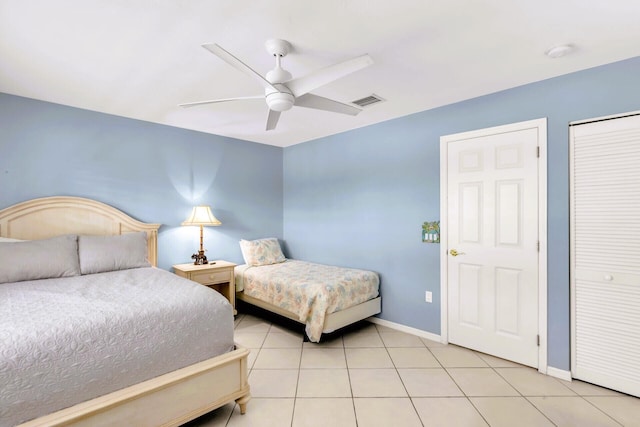 bedroom with light tile patterned floors, a closet, and ceiling fan