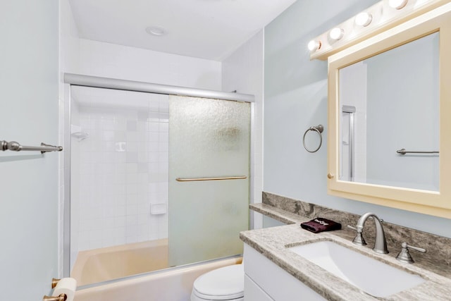 full bathroom with vanity, combined bath / shower with glass door, and toilet