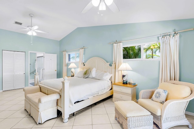 bedroom featuring ceiling fan, lofted ceiling, ensuite bath, and light tile patterned floors