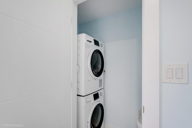 laundry room with stacked washer / dryer