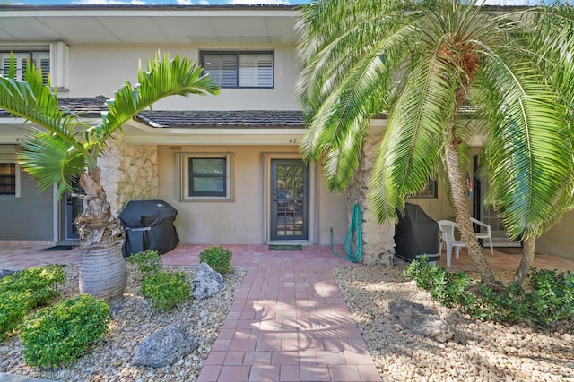 view of exterior entry featuring a patio