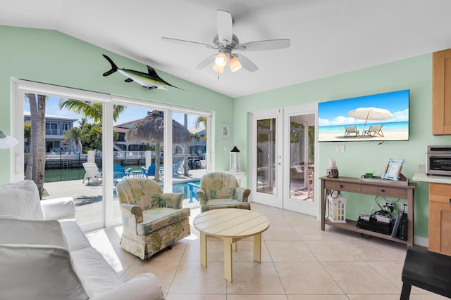 living room featuring french doors, ceiling fan, vaulted ceiling, and light tile patterned flooring