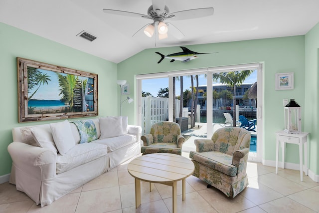living area with visible vents, ceiling fan, light tile patterned floors, and lofted ceiling