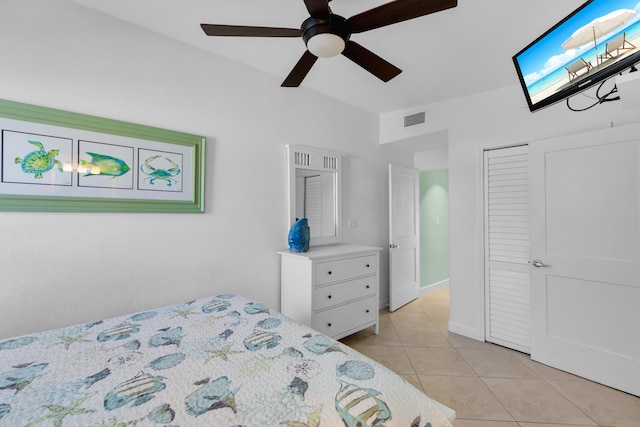 bedroom with visible vents, a ceiling fan, light tile patterned floors, and a closet