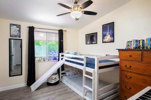 bedroom featuring vaulted ceiling, ceiling fan, and light wood-type flooring