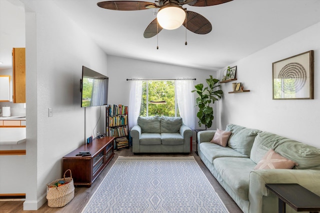 living room featuring lofted ceiling, ceiling fan, and light hardwood / wood-style flooring