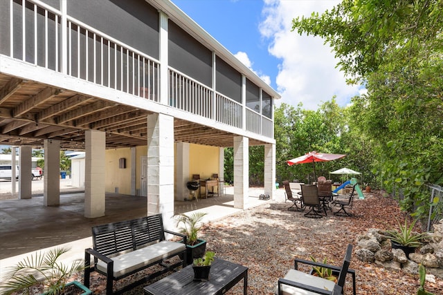 view of patio / terrace featuring a sunroom