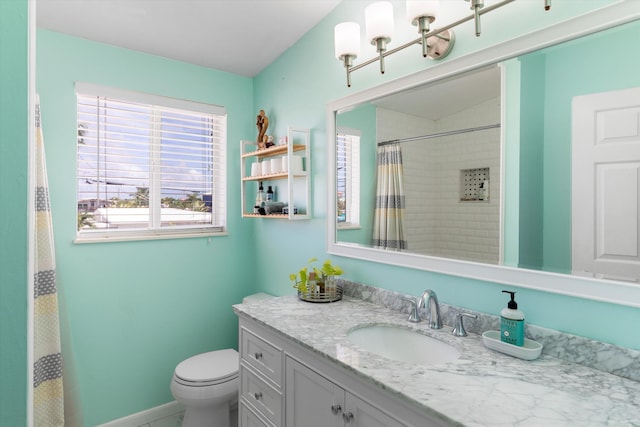 bathroom featuring vanity, toilet, and walk in shower