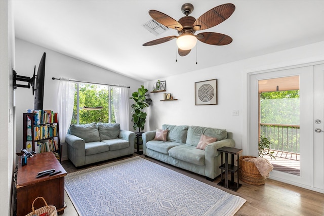 living room featuring vaulted ceiling, a wealth of natural light, ceiling fan, and light hardwood / wood-style floors