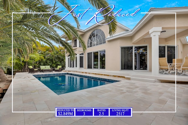 outdoor pool featuring an outdoor living space and a patio